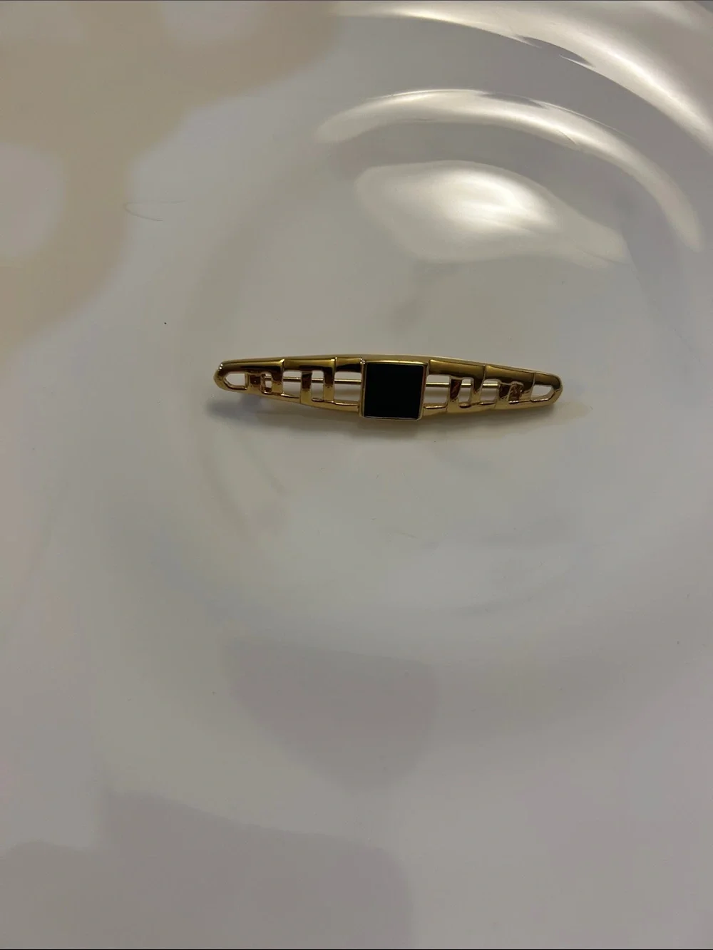 Monet vintage gold-tone tie bar features an openwork geometric design. 2 1/2”